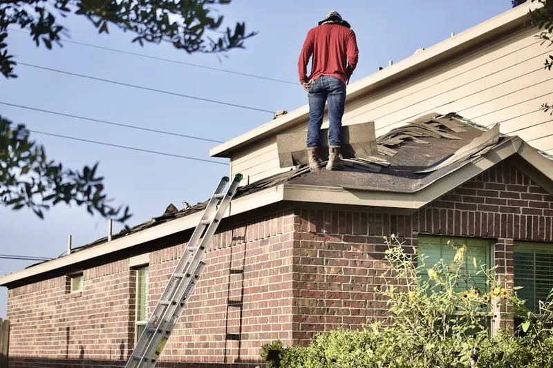 Professional roofer working on a residential roof in Fort Bragg